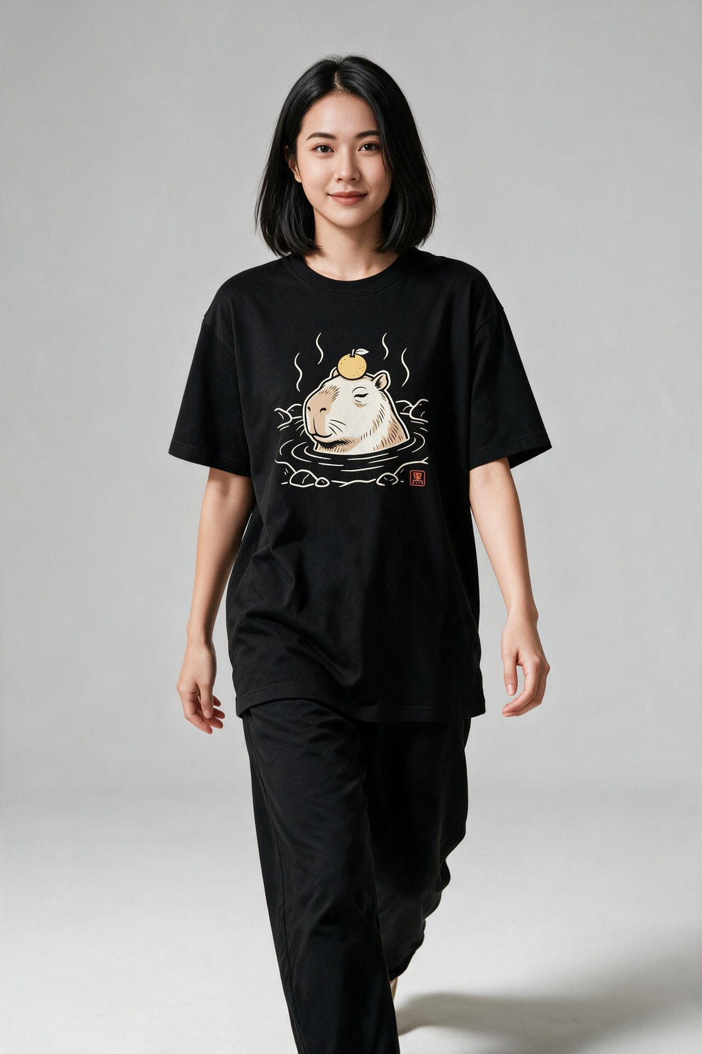 KUROI Kapibara Onsen oversized tee worn by model, walking