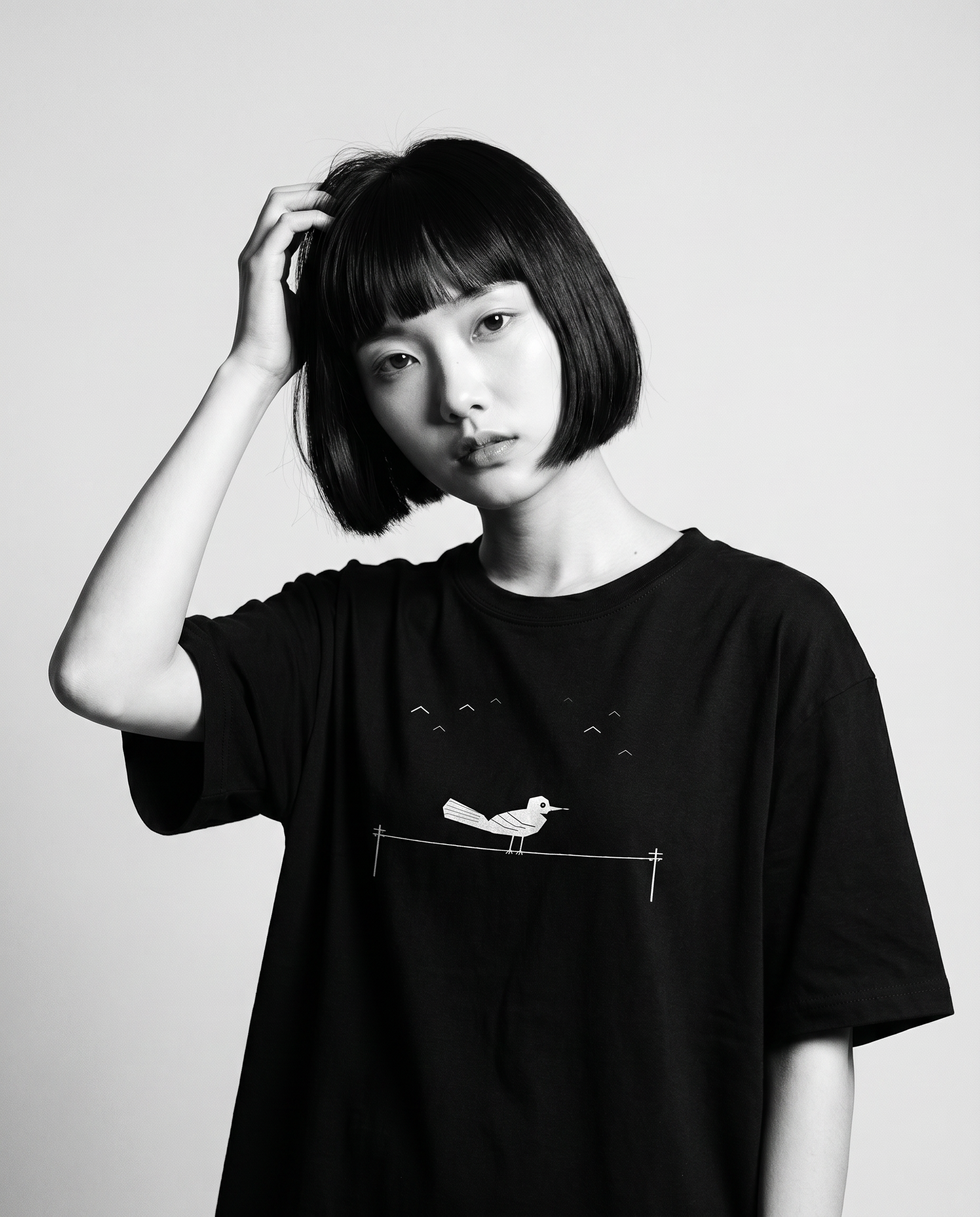 Nagi in the Kuroi Karasu Tee — hand in hair
