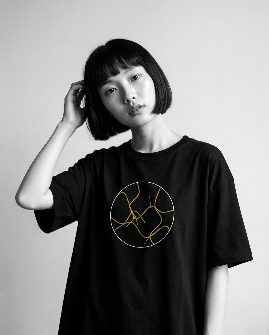 Nagi in the Kuroi Kintsugi Tee — hand in hair