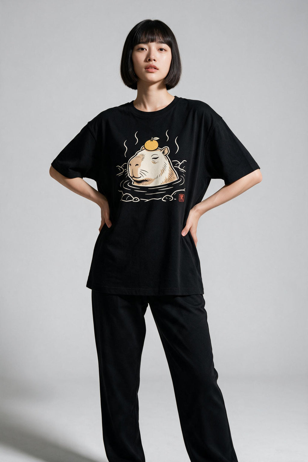 KUROI Kapibara Onsen oversized tee worn by model, hands on hips