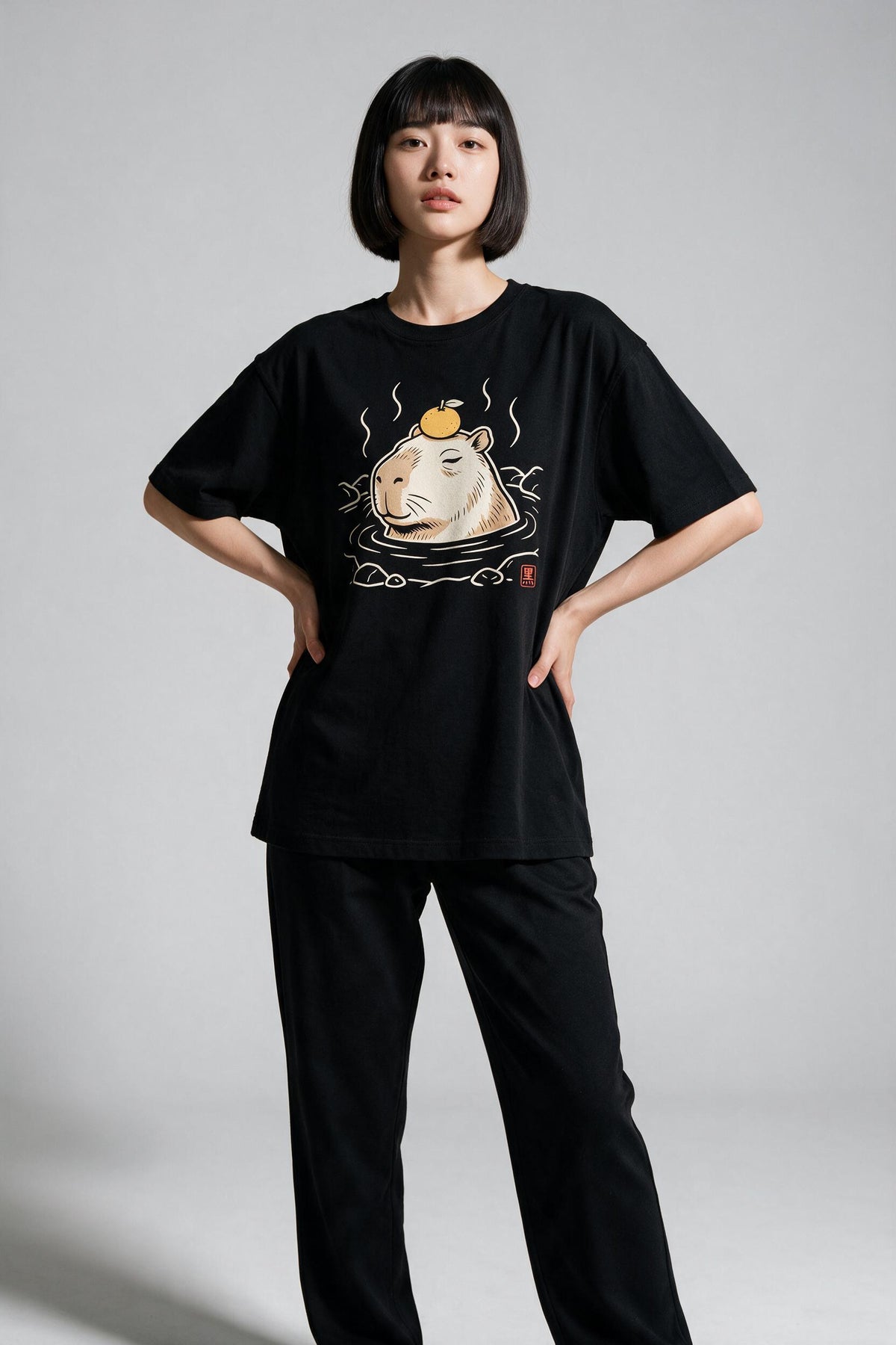 KUROI Kapibara Onsen oversized tee worn by model, hands on hips