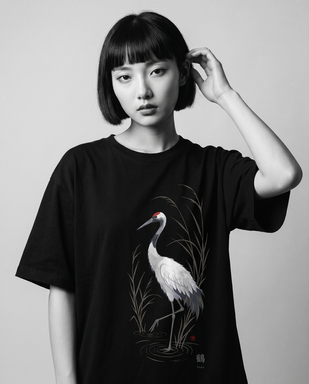 Nagi in the KUROI Tsuru Tee — hand in hair