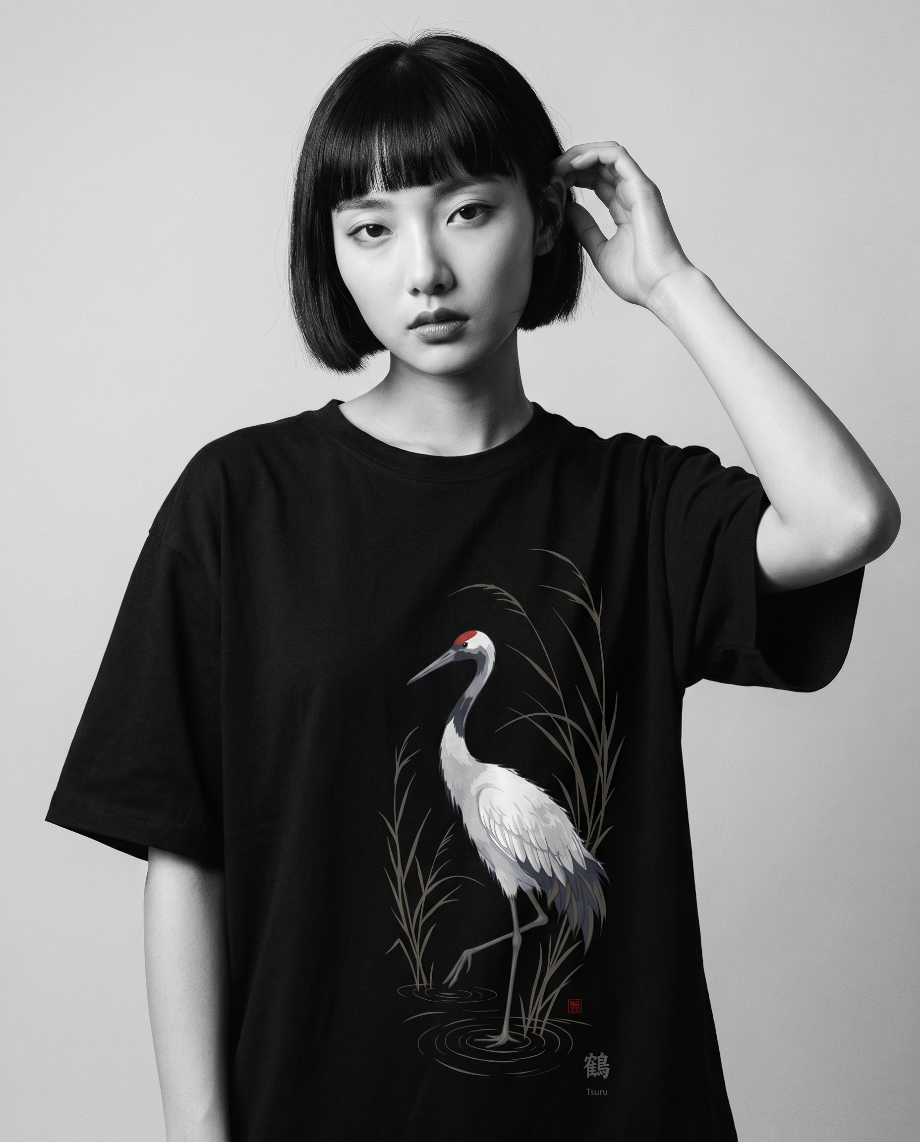 Nagi in the KUROI Tsuru Tee — hand in hair